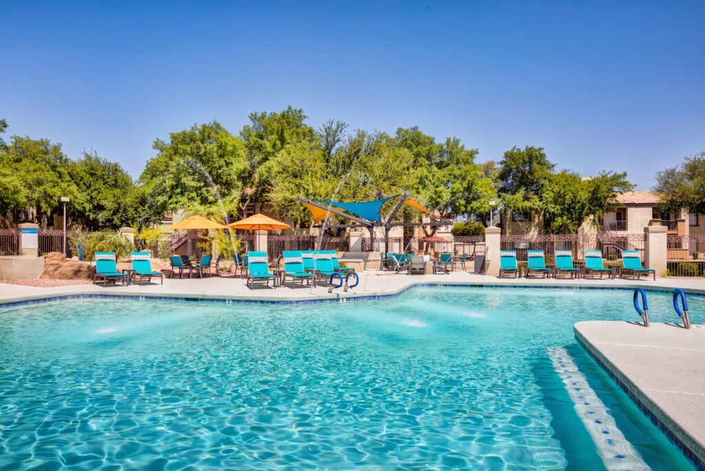 Apartment complex pool with blue pool chairs